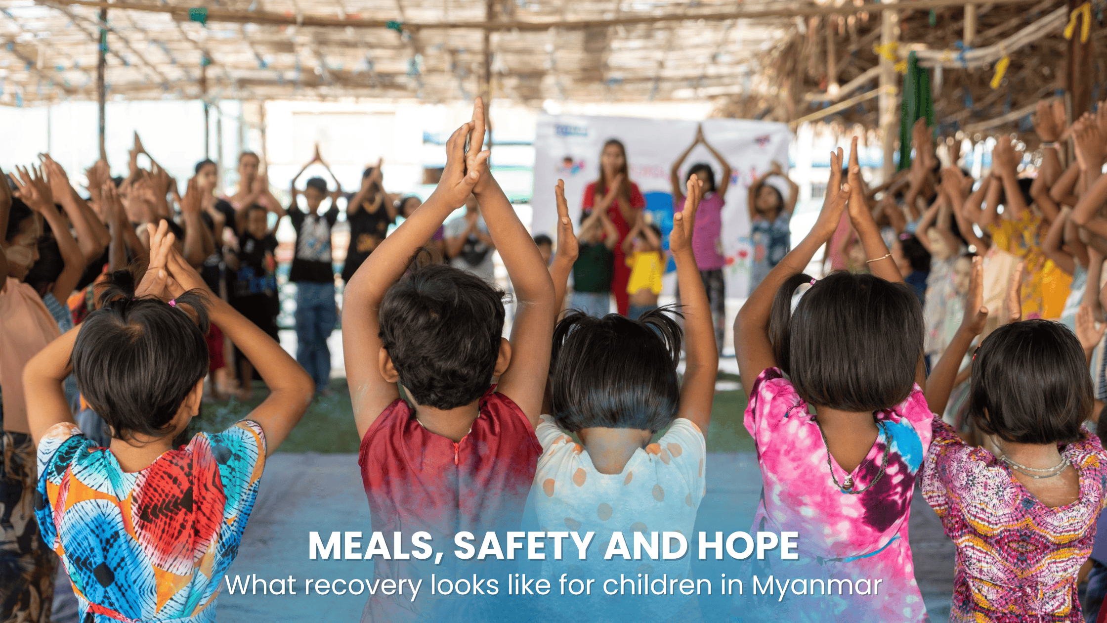 Children participate in a group activity at a Plan International-supported child-friendly space